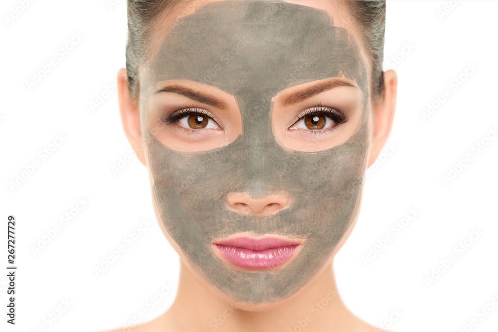 Clay mask facial treatment Asian beauty woman. Wellness and spa purifying peel off mask face portrait, isolated on white background. Cleansing skin care to remove blackheads and clean pores.