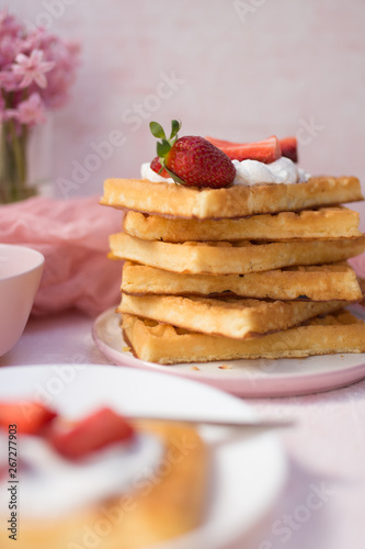 A stack of waffles with strawberries