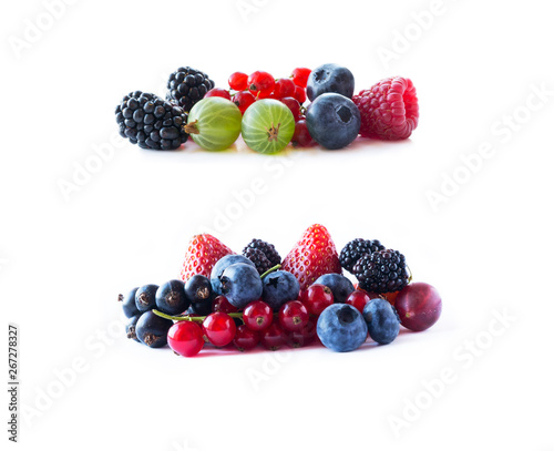 Ripe blueberries  blackberries  blackcurrants  strawberries  raspberries  gooseberries and red currants. Mix fruits on white background. Mix berries with copy space for text.