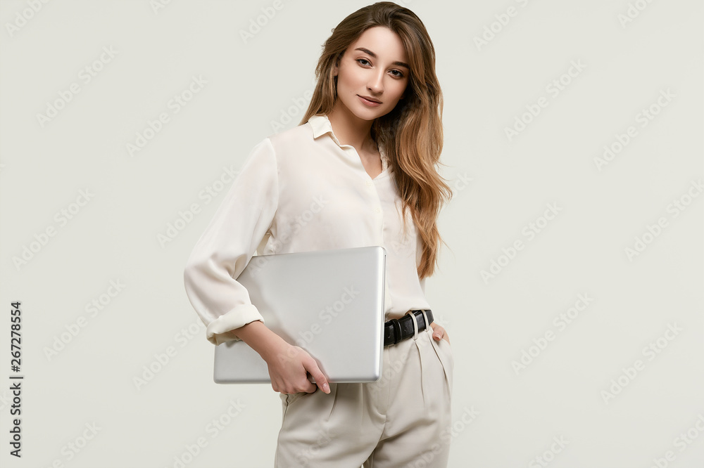 Gorgeous brunette model posing in white clothes with laptop Gorgeous brunette model posing in white clothes with laptop