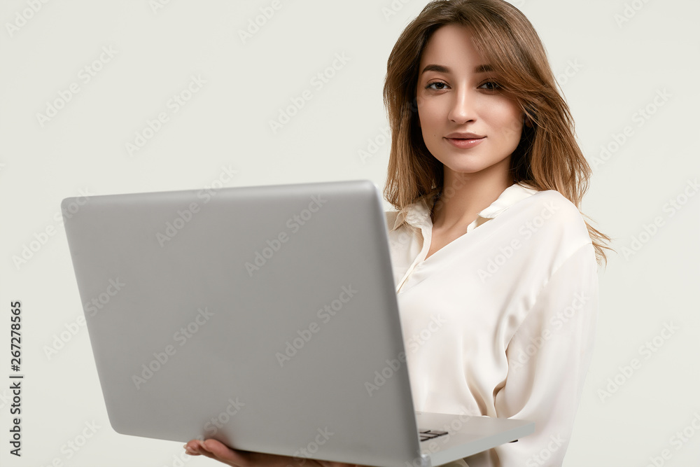 Gorgeous brunette model posing in white clothes with laptop Gorgeous brunette model posing in white clothes with laptop