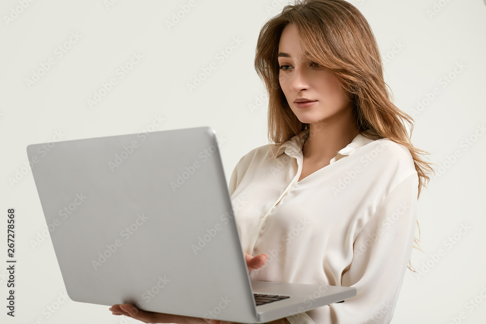 Gorgeous brunette model posing in white clothes with laptop Gorgeous brunette model posing in white clothes with laptop