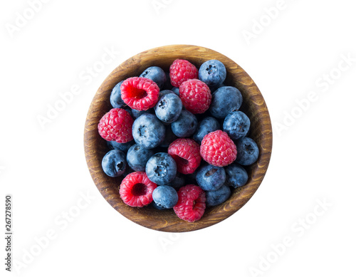 Top view. Berries in bowl on white background. Ripe raspberries and blueberries. Background of mix berries with copy space for text. Mix berries isolated on a white background. Various fresh summer.