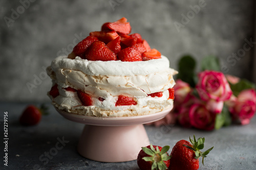 Pavlova with whipped cream and strawberries.