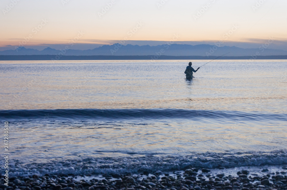 Naklejka premium A fisherman and Puget Sound gulf at mountain background