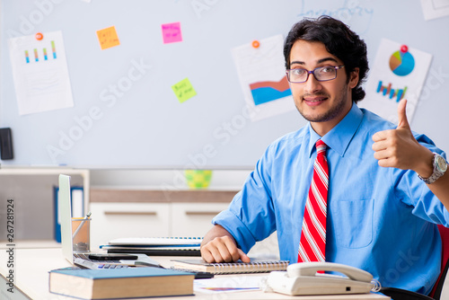 Young male financial manager working in the office 