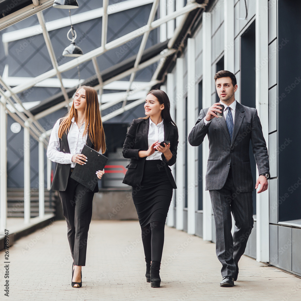 Three young and successful business people going to business centre! Three young and successful business people going to business centre!