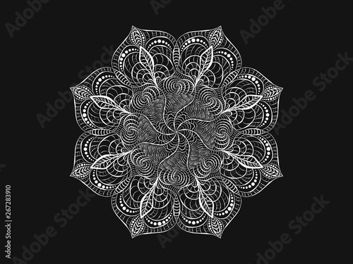 Round white crocheted lace doily. Decorative mandala. Plant and wavy natural elements. The stylization of the sun