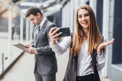 Image of young business colleagues couple  take selfie by mobile phones.