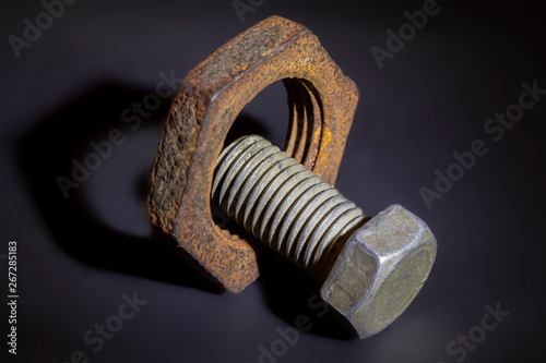 Bolt and nut on dark background