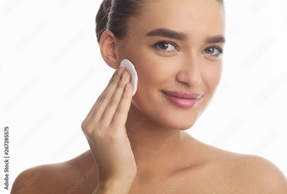 Removing Makeup. Woman Cleaning Face With Cotton Pad