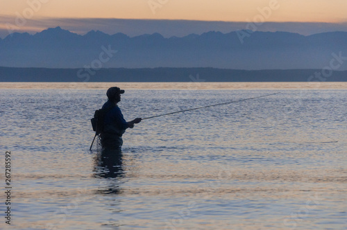 A fisherman tries to catch a fish in the Puget Sound water