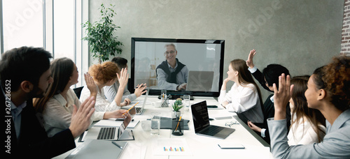Business team having video call with senior boss at office photo