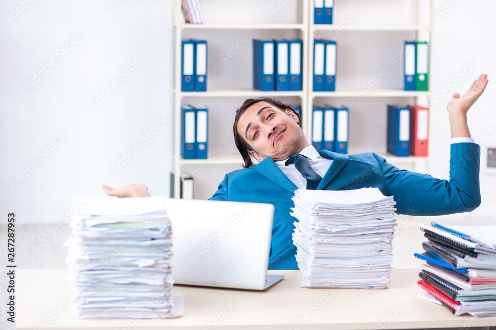 Young male employee unhappy with excessive work Young male employee unhappy with excessive work