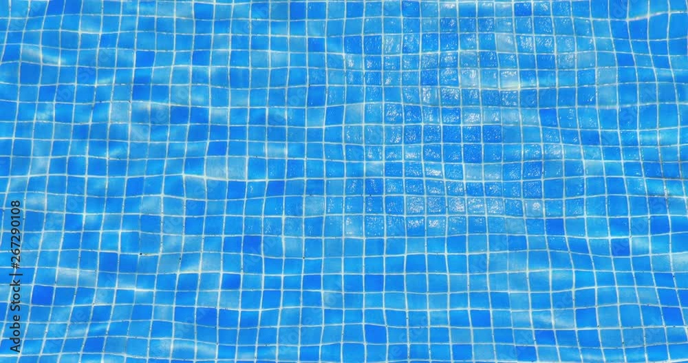 water ripples in swimming pool, blue tile background, 4k loop-ready