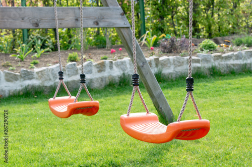 empty swing on playground in the garden