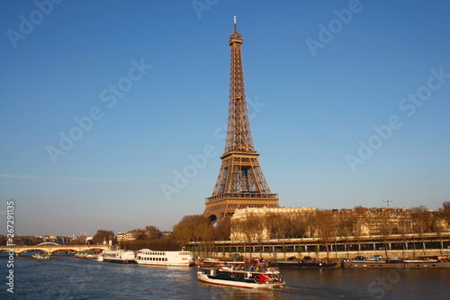 The Eiffel tower in evening and river boat on the seine river in Paris, Paris capital and the most populous city of France © Picturereflex