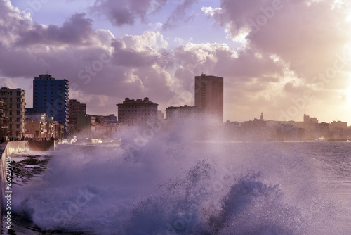 Stormy weather hitting The Malecon in Havana  big waves crash over the seawall in sunset  Cuba