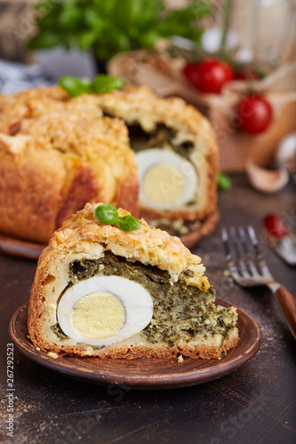 Delicious closed savory pie with eggs and spinach filling
