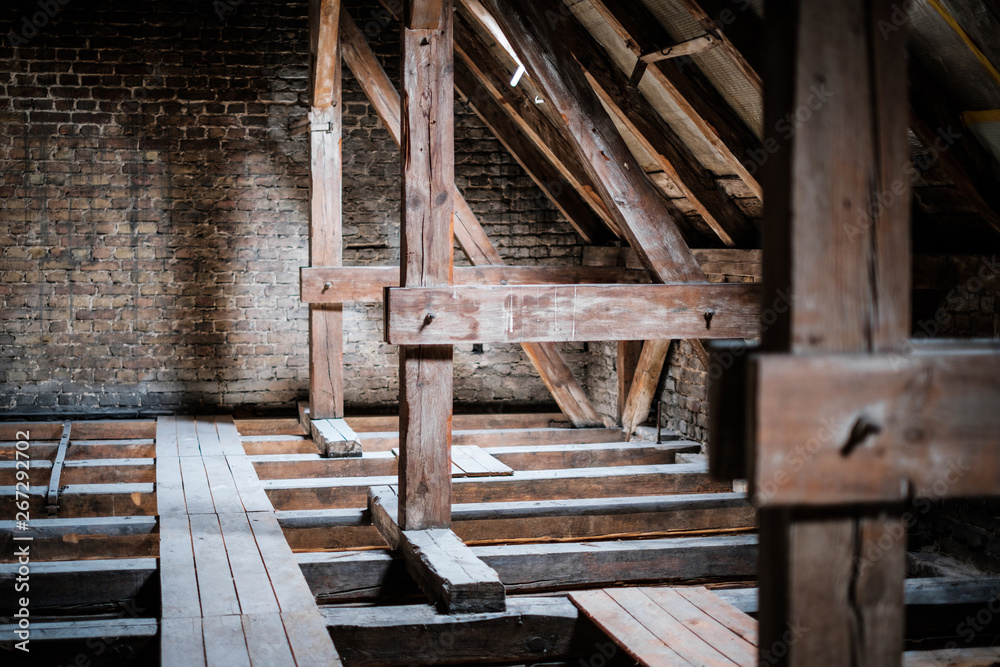 roof beams in old, empty attic / loft before renovation / construction concept