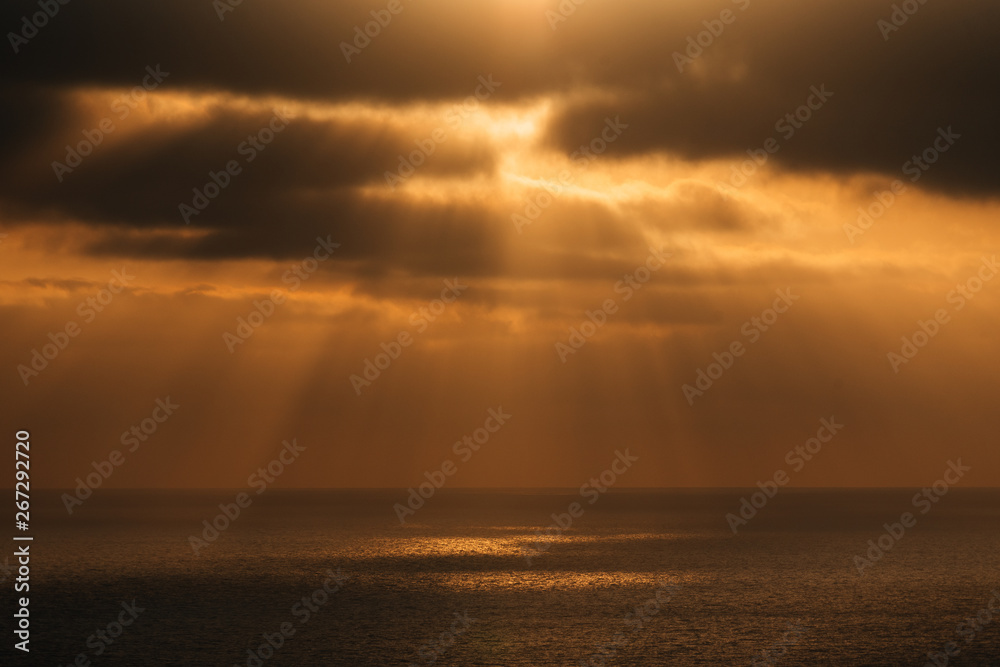 Dramatic sun rays over the Pacific Ocean at sunset from Torrey Pines State Reserve in San Diego, California