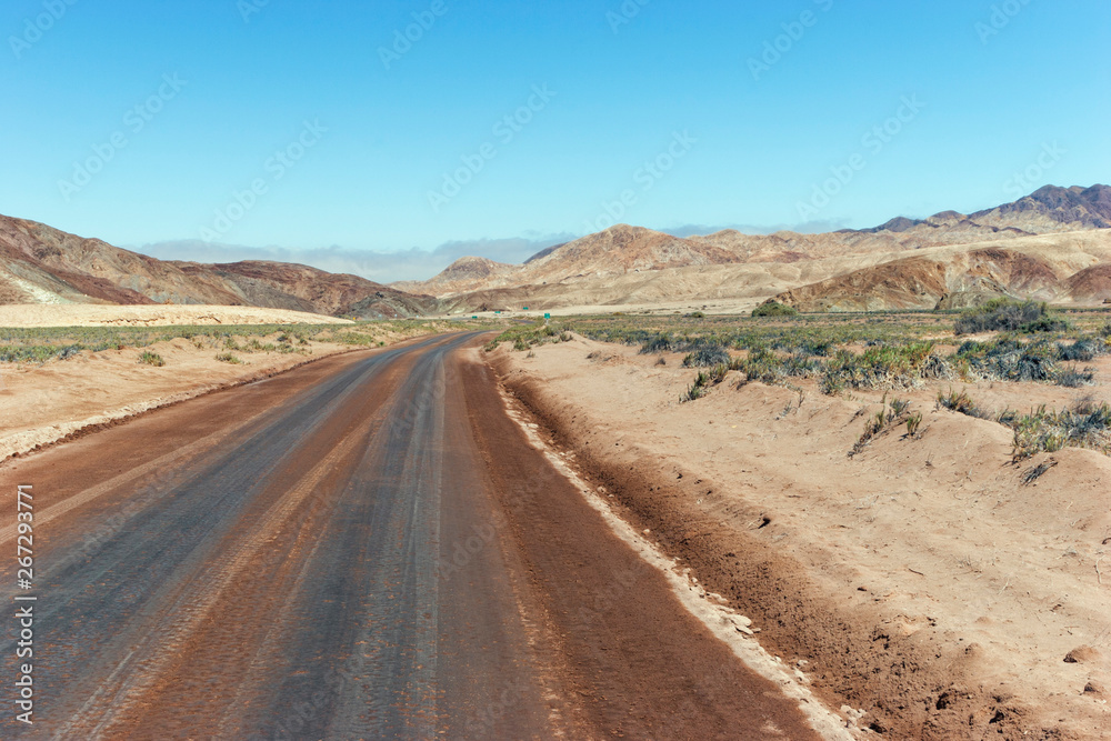 Road running through desert landscape, Atacama, Chile .