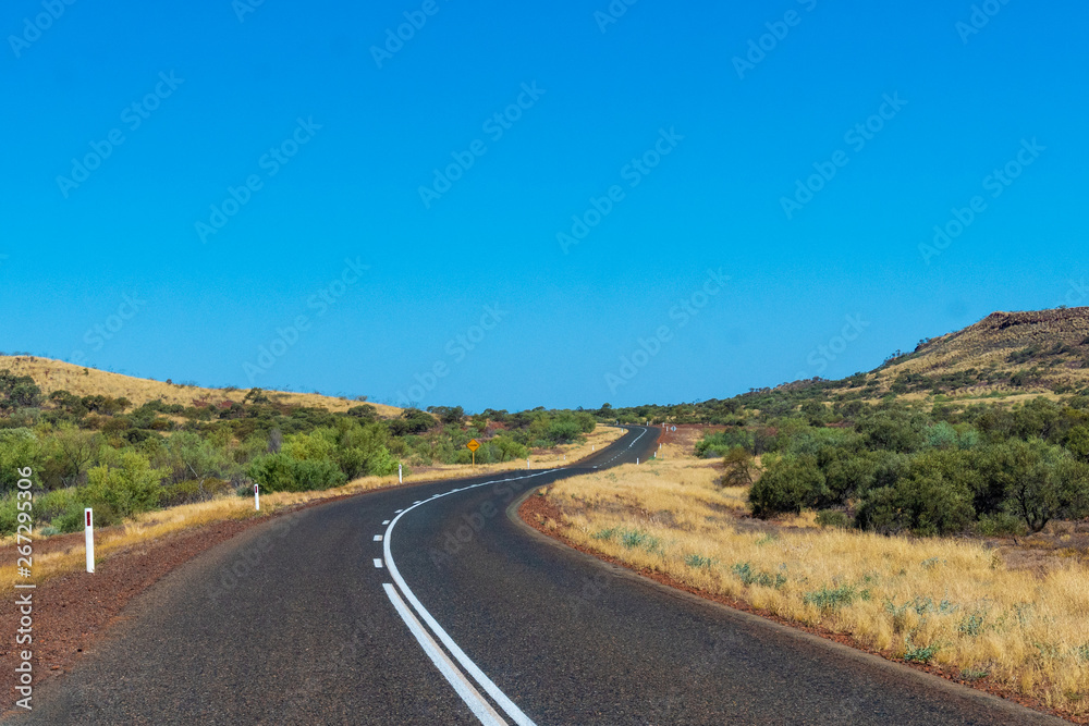 Purple iron ore sand next to road at Karijini National Park Australia