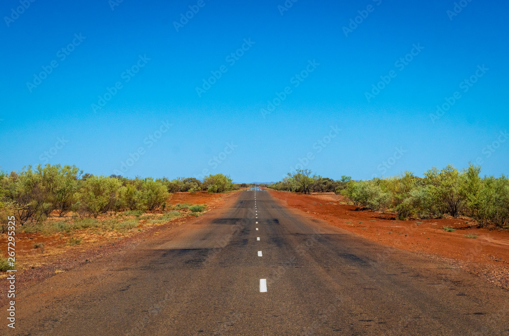 Red dust next to road at Karijini National Park purple iron ore ground Red dust next to road at Karijini National Park purple iron ore ground