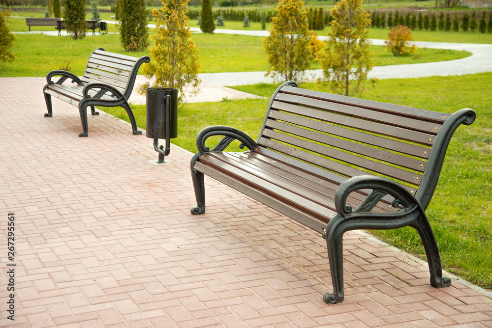 Photo of benches in green park, nobody, spring season Photo of benches in green park, nobody, spring season