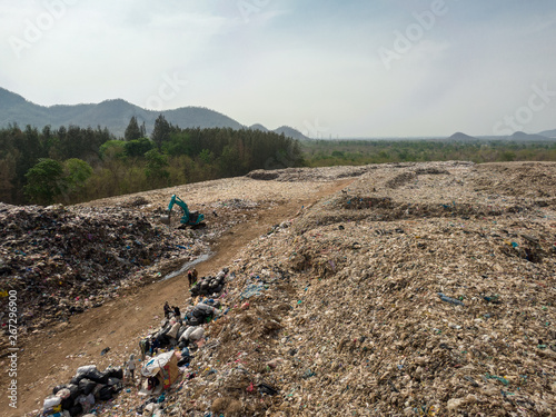 city dump,  A ton of household waste on the huge landfill and people sorting garbage, aerial view.