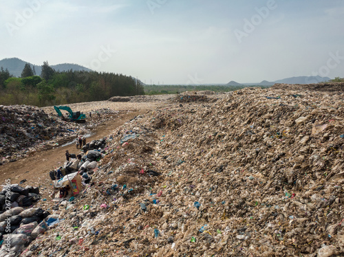 city dump,  A ton of household waste on the huge landfill and people sorting garbage, aerial view.