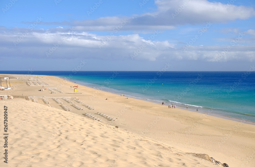 View from above on beach with golden sand and ocean in Morro Jable, Fuerteventura.