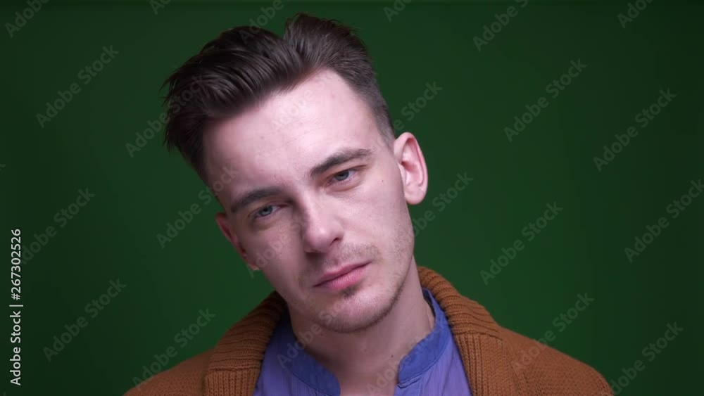 Closeup shoot of adult attractive man dancing with joy in front of the camera with background isolated on green Closeup shoot of adult attractive man dancing with joy in front of the camera with background isolated on green