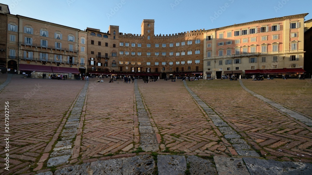 Scenic view of a section of Piazza del Campo medieval square in Siena town, Tuscany, Italy, with the brick pavement in evidence 