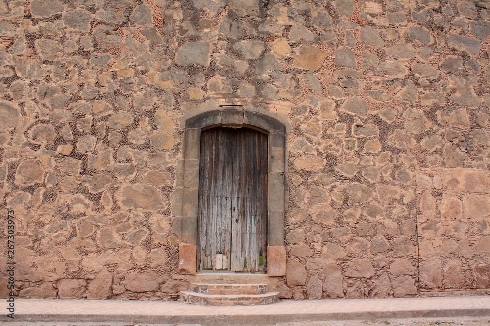 Ancient adobe and stone facade in a mexican house