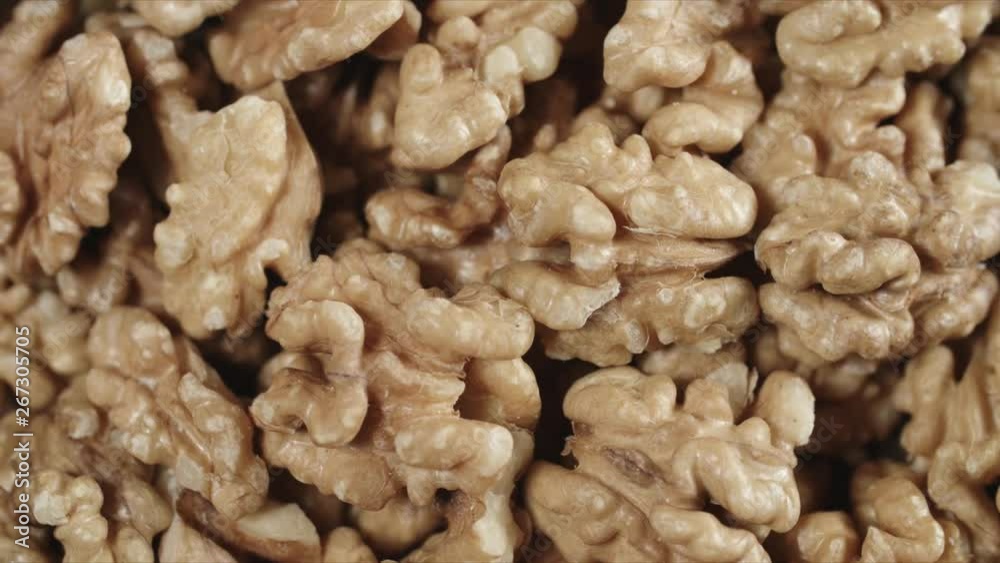 Dry walnut background, close up nut, rotation top view. Food background