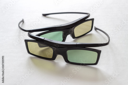 Set of two 3D glasses for watching movies and TV shows on the TV screen. On light background