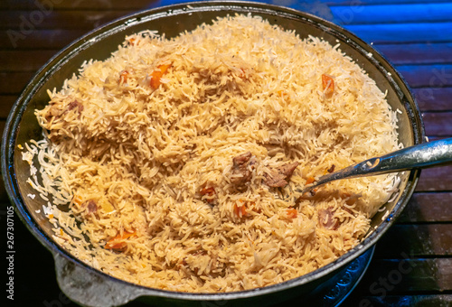 step-by-step process of cooking pilaf in a cast iron cauldron