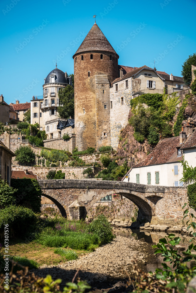View from the docks of the vaulted bridge and the old medieval town of Semur en Auxois - France
