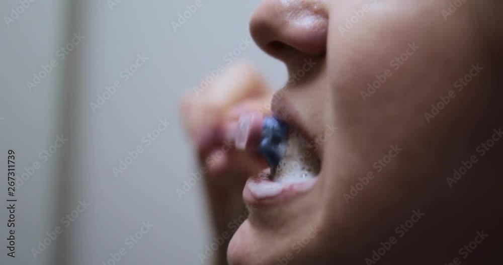 Girl brushing her teeth in the bathroom