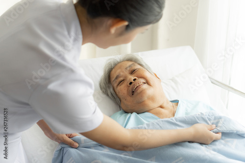 the nurses are well good taken care of elderly patients in hospital bed patients feel happyness - medical and healthcare concept