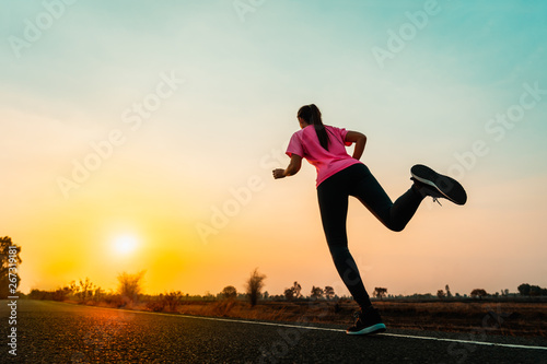 Young woman enjoy running outside with beautiful summer evening in the countryside.