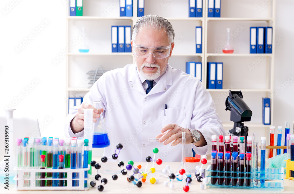 Old male chemist working in the lab Old male chemist working in the lab