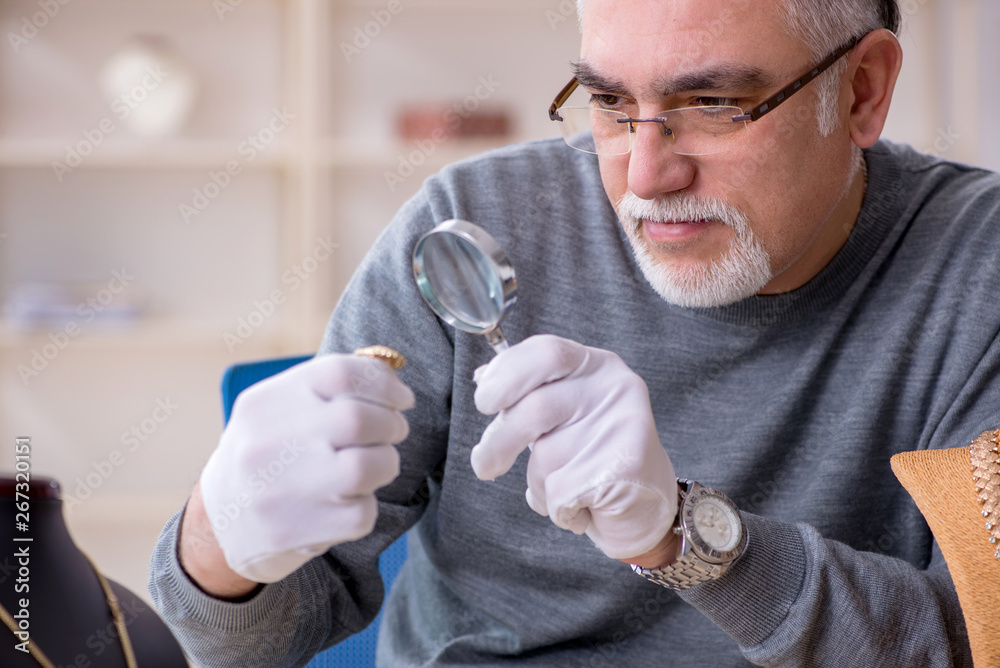 White bearded old jeweler at workshop White bearded old jeweler at workshop
