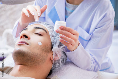 Young handsome man visiting female doctor cosmetologist