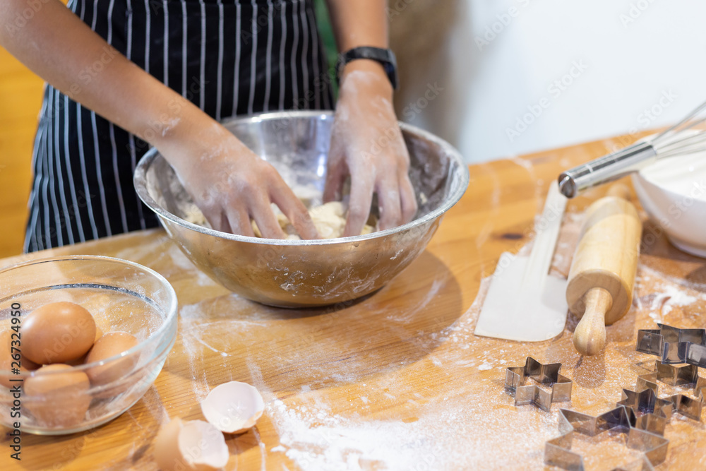 Fototapeta premium Girls mixing dough, making cookies in the kitchen