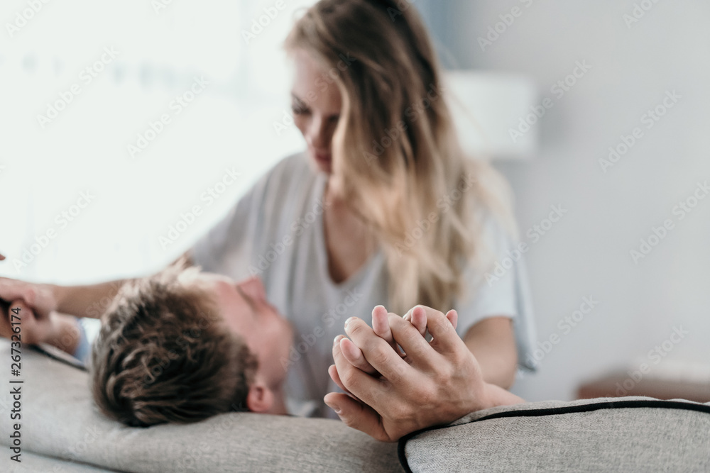 couple romantic in love. woman sitting on man's lap and hold hand. focus on hand couple romantic in love. woman sitting on man's lap and hold hand. focus on hand