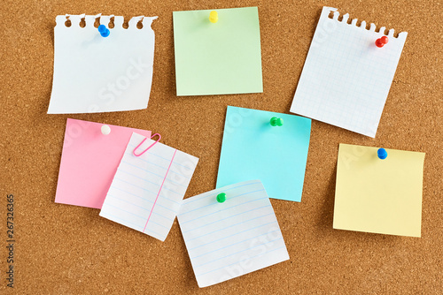 colored paper stickers on a cork board background photo