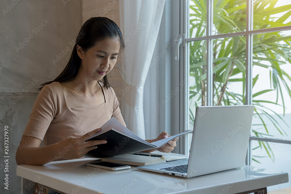 Asian woman relaxing and reading book at home. Asian woman relaxing and reading book at home.