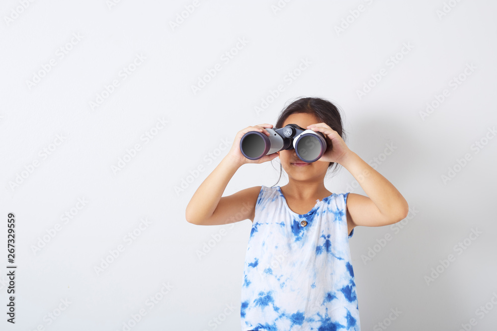 Child girl looking into binocular Child girl looking into binocular